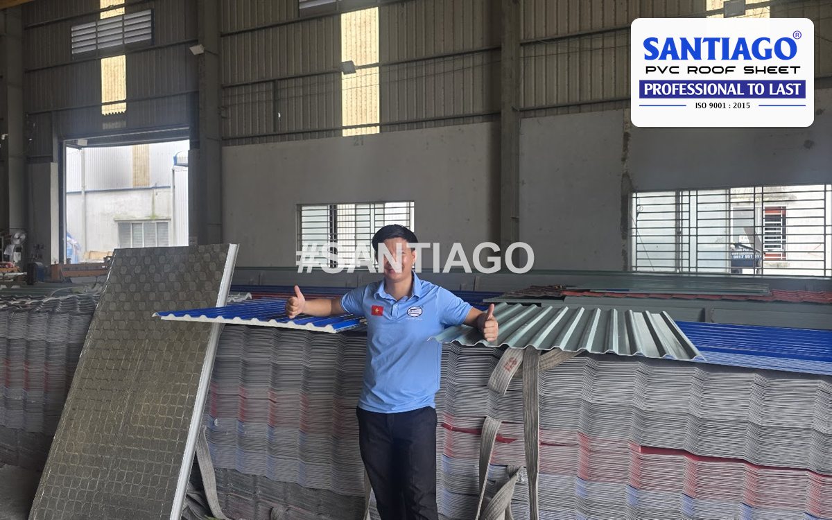 A Santiago staff member beside stacks of ASA/PVC roofing sheets in the warehouse, October 2025