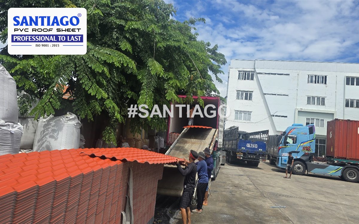 Orange ASA/PVC roof tiles being loaded onto a truck in the Santiago factory yard, June 2026